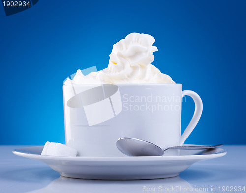 Image of coffee and cream on blue background