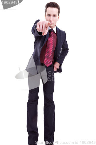 Image of young business man in suit pointing at you 