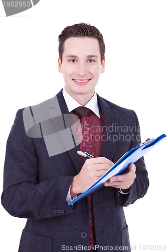 Image of Business man writing on clipboard