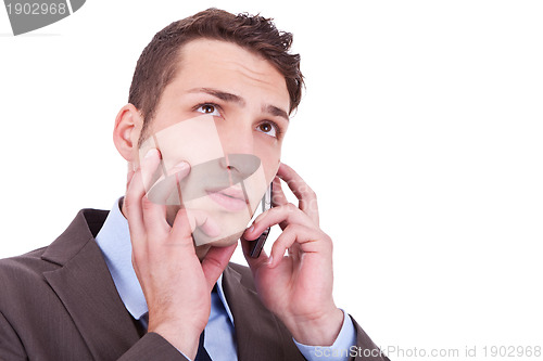 Image of contemplative businessman talking on phone