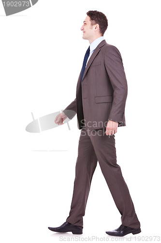 Image of  side view of a young businessman walking