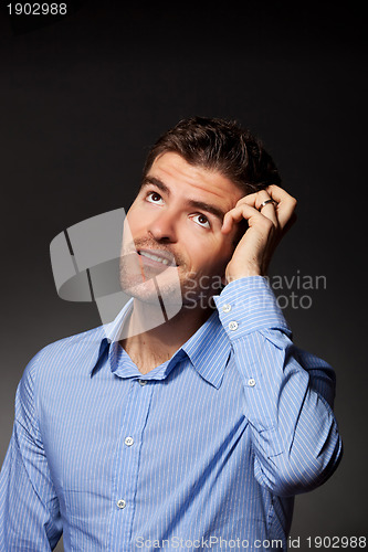 Image of casual young pensive businessman