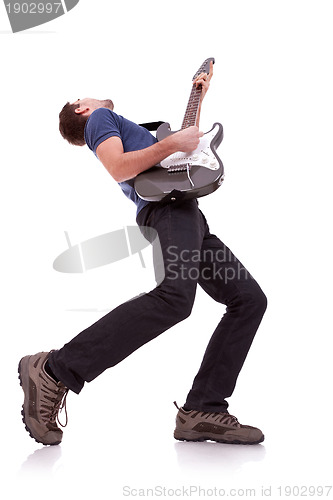 Image of wide angle of a young guitarist