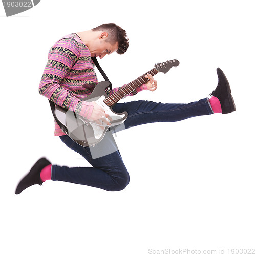 Image of passionate guitarist jumps in the air 