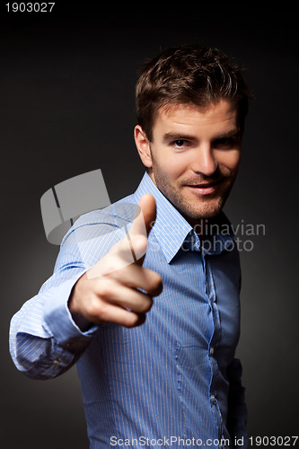 Image of fashion young man pointing at the camera