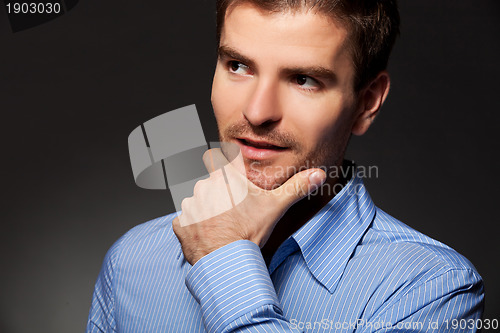 Image of young business man thinking