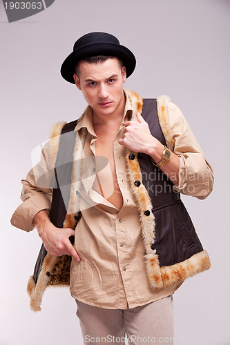 Image of man with hat and funny fur coat posing 