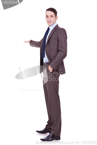 Image of Full length of successful business man presenting
