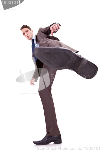 Image of kicking business man