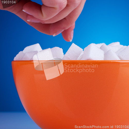 Image of  woman reaching for some sugar cubes