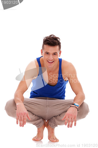 Image of man squatting down in bare feet 