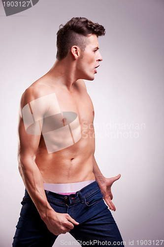 Image of muscular fashion model in a dance pose