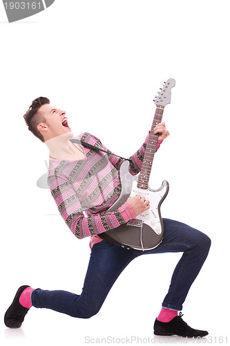 Image of screaming young guitarist playing his guitar