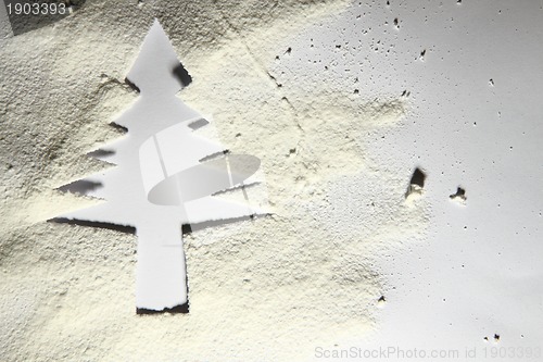 Image of christmas tree from the paper and snow