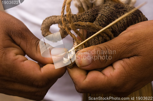 Image of Sharpening a blowgun dart