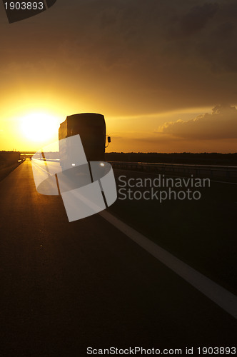 Image of Truck traveling at sunset