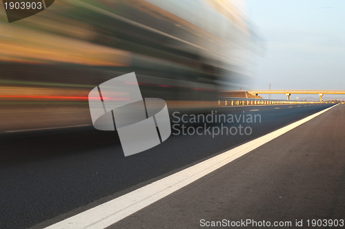 Image of Bus traveling on highway. Motion blur effect