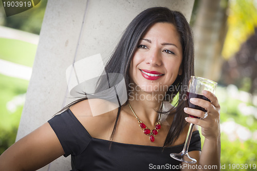 Image of Attractive Hispanic Woman Portrait Outside Enjoying Wine