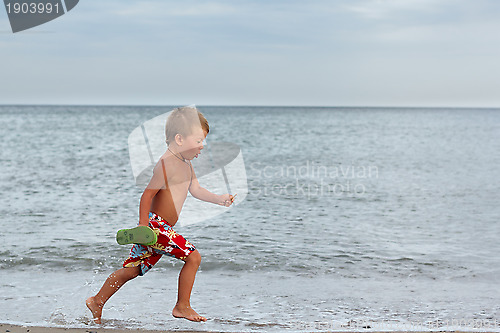 Image of Little boy running at the seashore