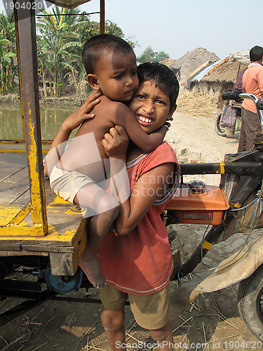 Image of Sayan Payne holding his little brother Rajneesh at remote village in Sundarbands, West Bengal, India