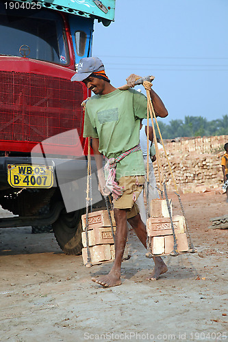 Image of Brick field workers carrying complete finish brick from the kiln