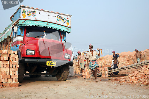 Image of Brick field workers carrying complete finish brick from the kiln