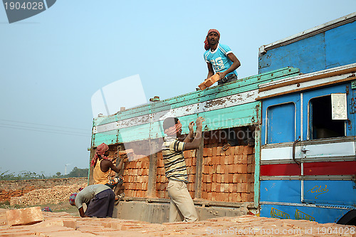 Image of Brick field workers carrying complete finish brick from the kiln