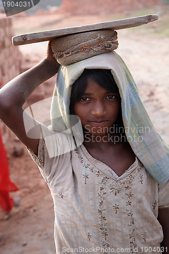 Image of Brick field workers carrying complete finish brick from the kiln