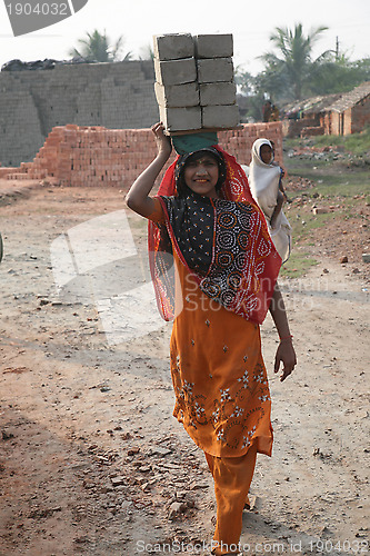 Image of Brick field workers carrying complete finish brick from the kiln