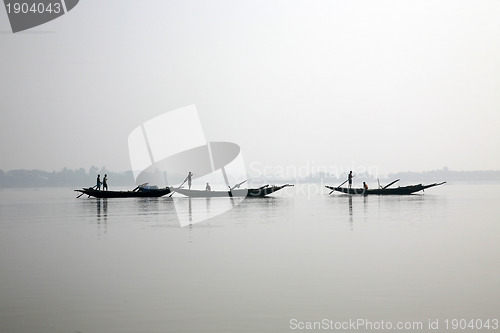 Image of Some fishermen on a boat in Sunerband, India