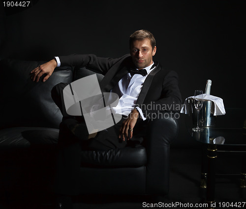 Image of Sexy man in tuxedo waiting for his date