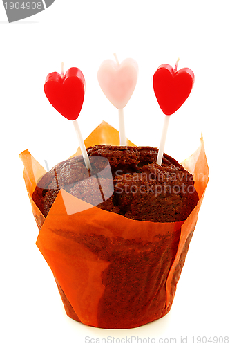 Image of Chocolate cake and candles in the shape of heart. 
