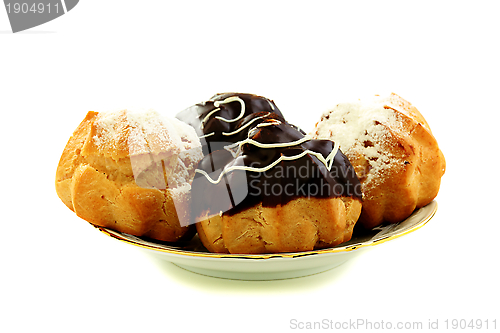 Image of Eclairs with frosting in a plate.