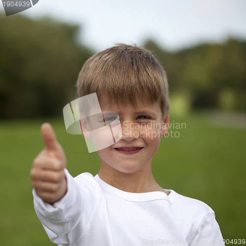 Image of Young boy showing thumbs up