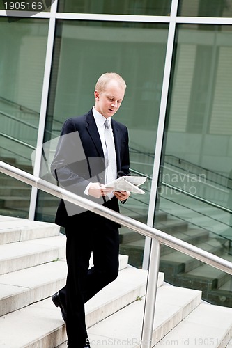 Image of succsessful business man with tie and black dress 