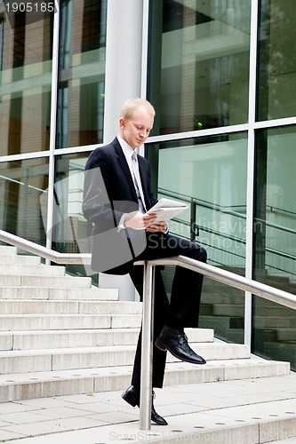 Image of succsessful business man with tie and black dress 