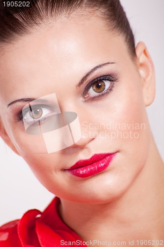 Image of beautiful brunette woman with red lips and makeup