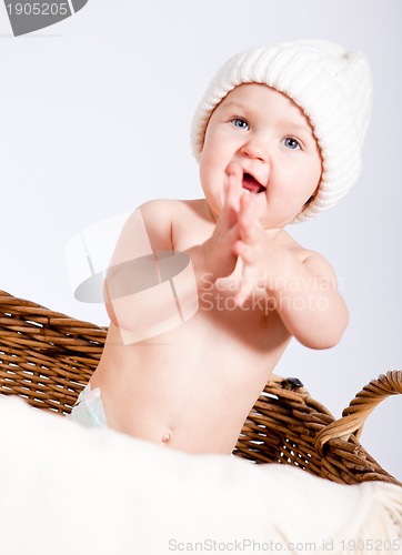 Image of cute little baby infant in basket with teddy 