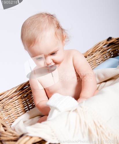 Image of cute little baby infant in basket with teddy 