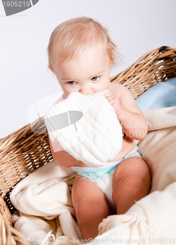 Image of cute little baby infant in basket with teddy 