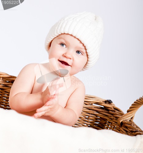 Image of cute little baby infant in basket with teddy 