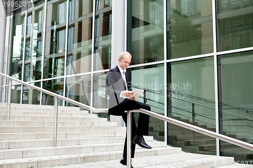 Image of succsessful business man with tie and black dress 