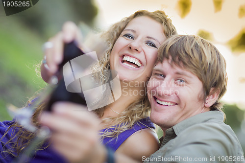 Image of An Attractive Couple Enjoying A Glass Of Wine in the Park