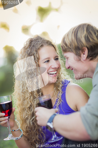 Image of An Attractive Couple Enjoying A Glass Of Wine in the Park