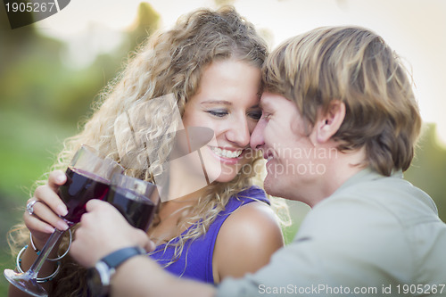 Image of An Attractive Couple Enjoying A Glass Of Wine in the Park