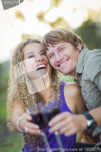 Image of An Attractive Couple Enjoying A Glass Of Wine in the Park