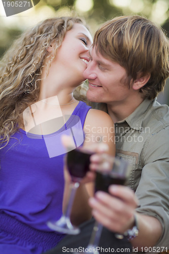 Image of An Attractive Couple Enjoying A Glass Of Wine in the Park