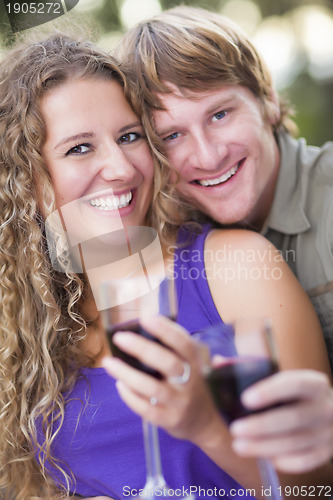 Image of An Attractive Couple Enjoying A Glass Of Wine in the Park