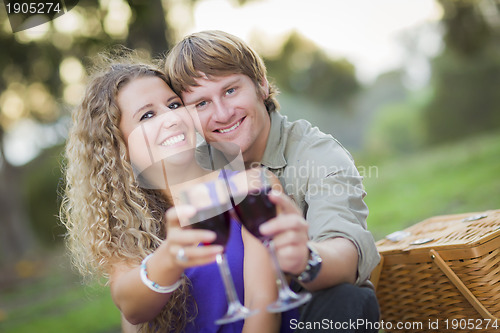 Image of An Attractive Couple Enjoying A Glass Of Wine in the Park