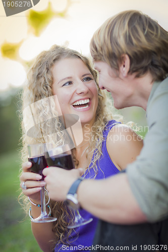 Image of An Attractive Couple Enjoying A Glass Of Wine in the Park